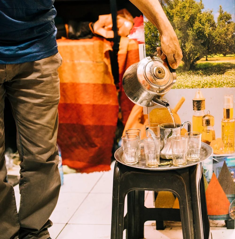 Chai being poured into glasses at a Chai Garam catering setup